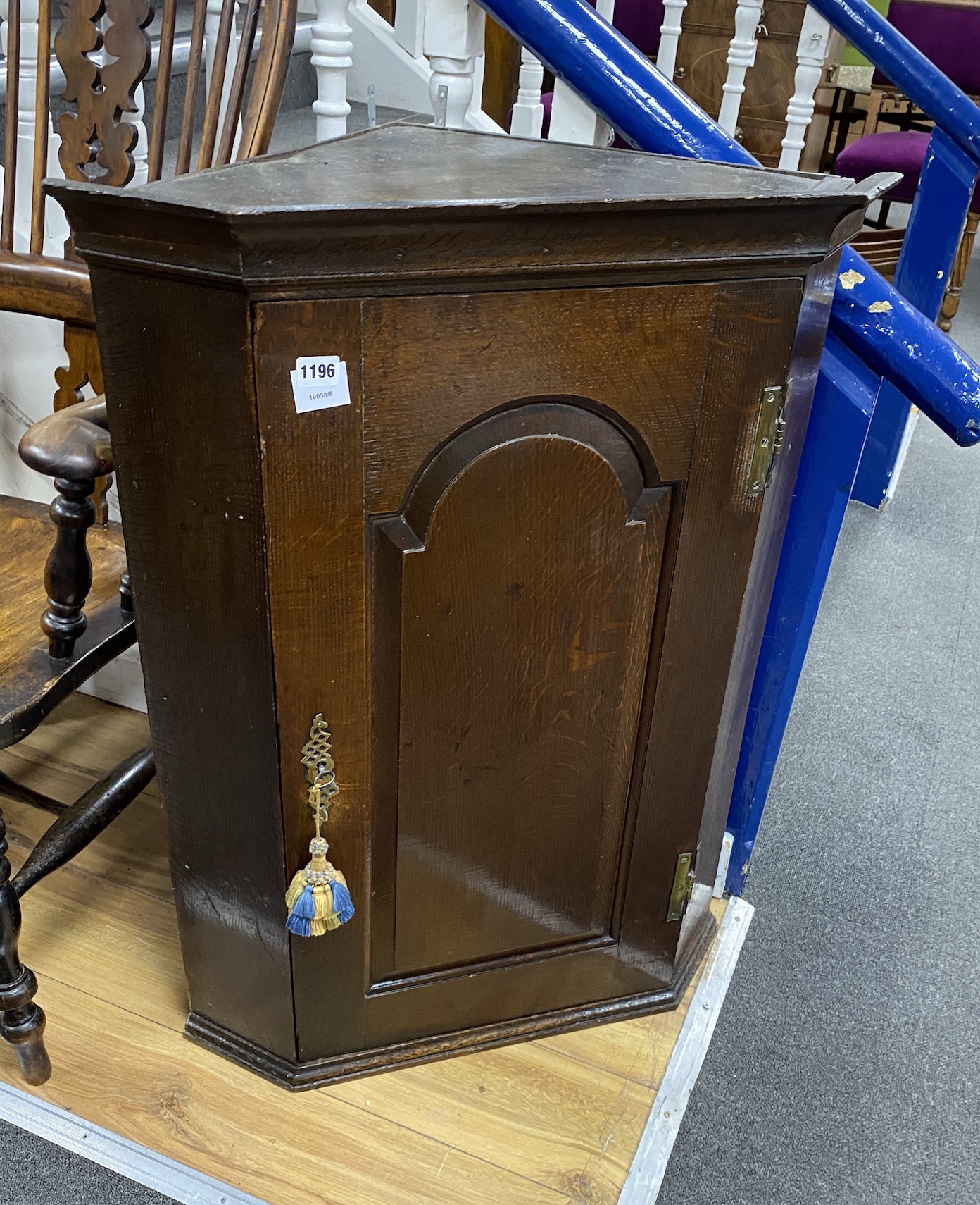 A George III oak hanging corner cupboard, width 69cm, depth 45cm, height 91cm